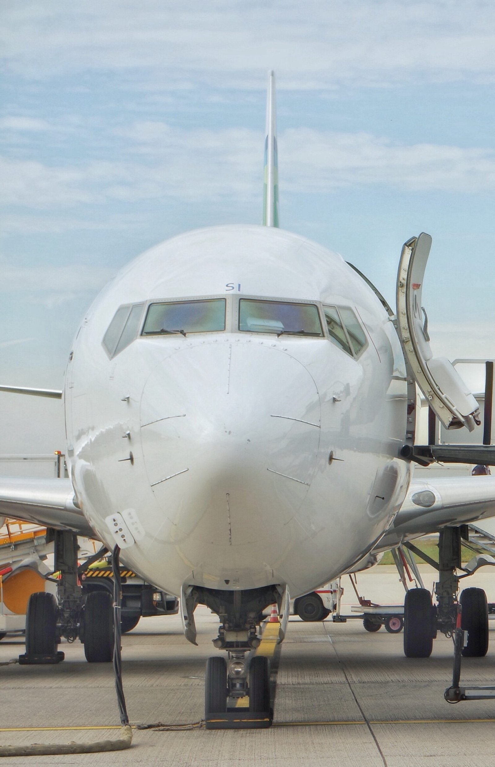 white commercial passenger jet viewed from the front